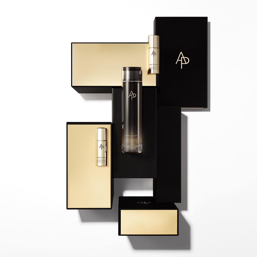 Cosmetic products with gold and black packaging on a white background