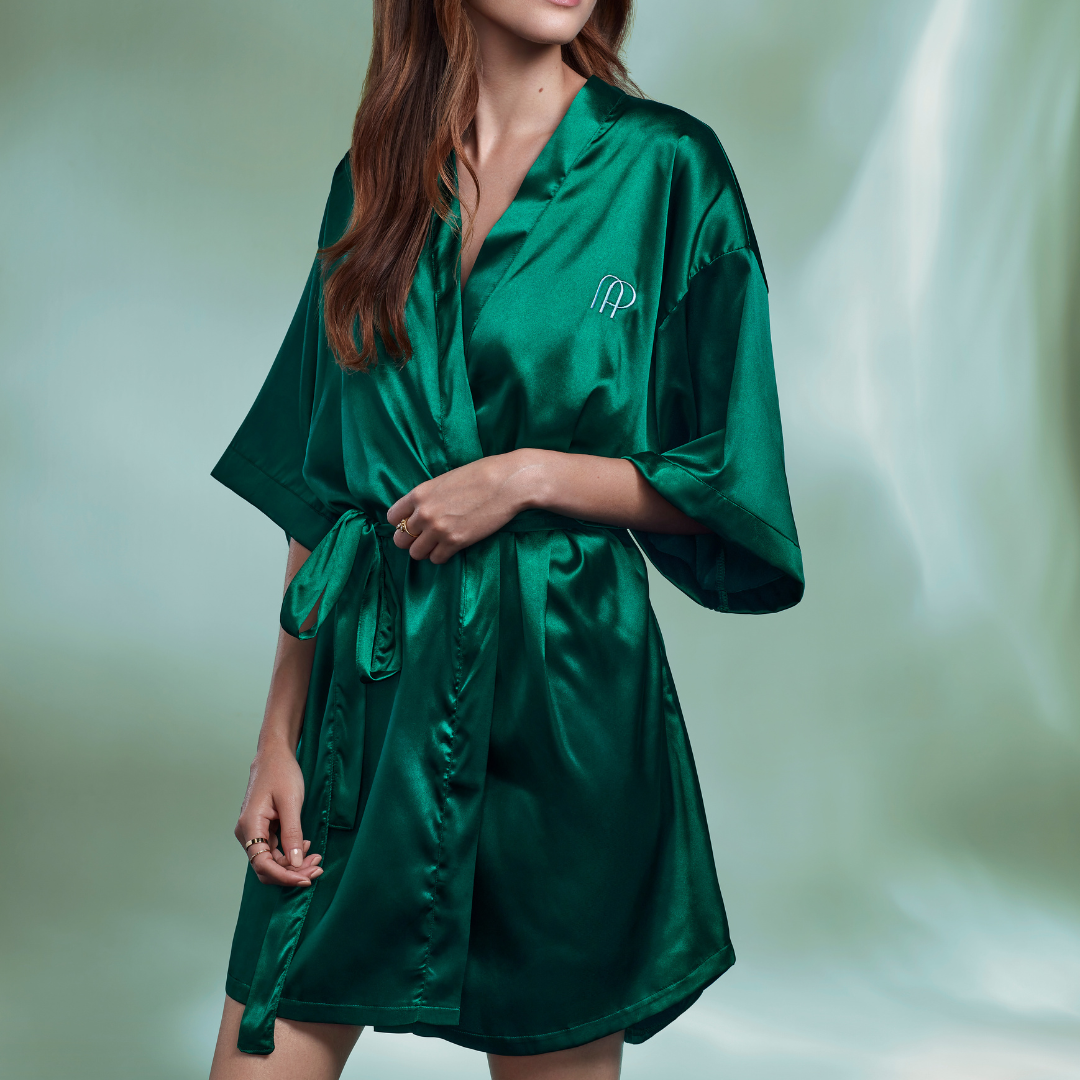 AMORE PACIFIC dark green satin robe on model with green background